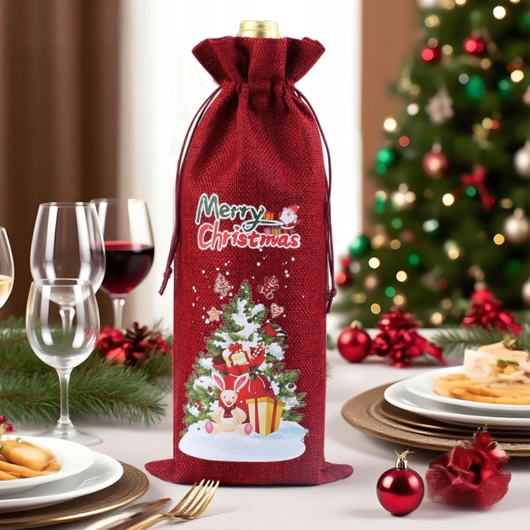 Czerwone etui świąteczne na butelkę ze sznurkiem – dekoracyjne opakowanie z nadrukiem Merry Christmas obok prezentów.